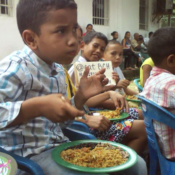 Venzuelan child enjoying a meal paid for by the charity we helped brand