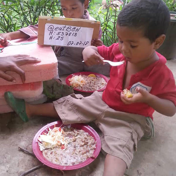 Adorable children in Venezuala eating a donated meal